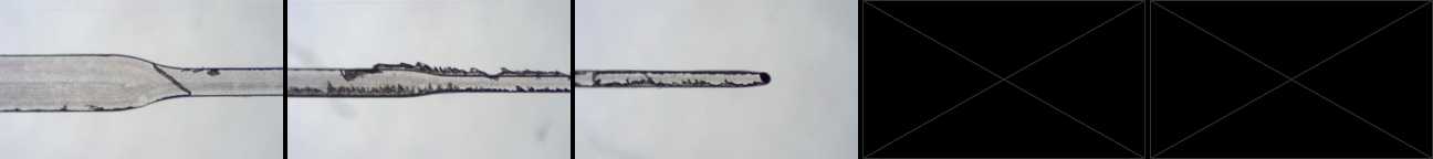 Close-up of a micromilled microfluidic channel that steps down from 500 microns to 150 microns. The channel geometry is defined but there is pronounced burr, especially at 150 microns.